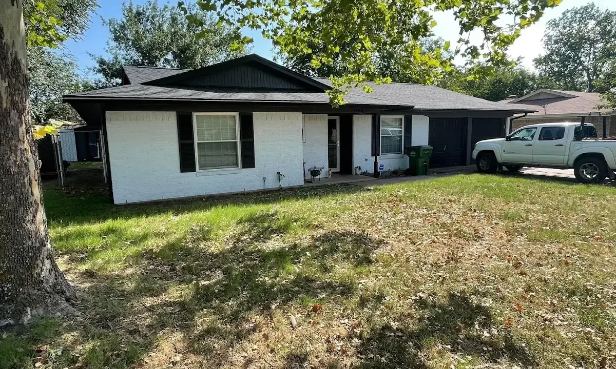 Professional roofing crew working on a residential roof in Warren